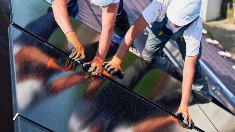 Solar installers on roof with solar panels