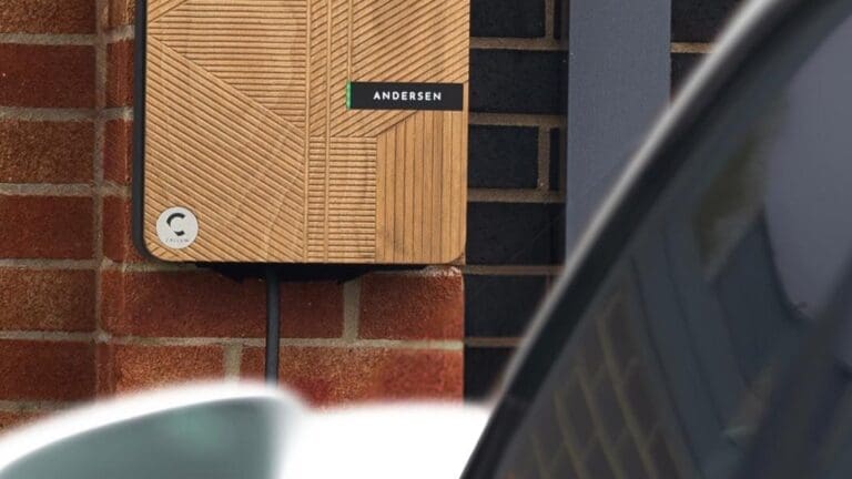 A designer charge point sits on the outside wall of a house.