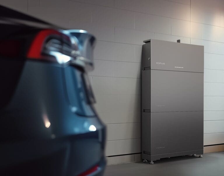 A new battery storage solution displayed against a garage wall with an EV in the foreground