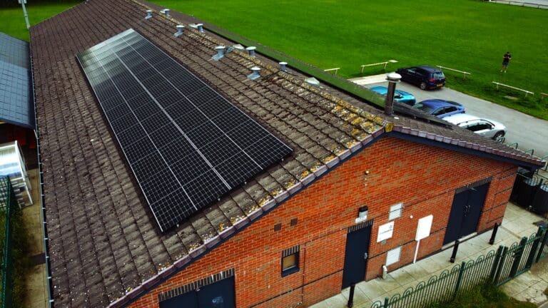 View of building from above with solar panels embedded in the roof.