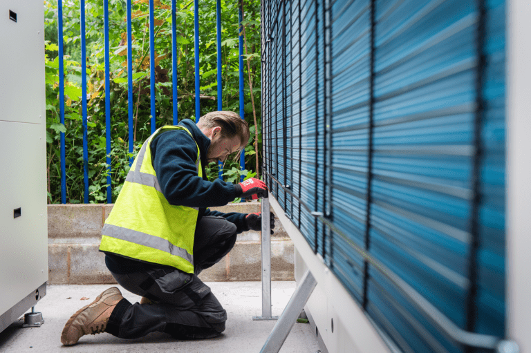 Installer working on heat pump