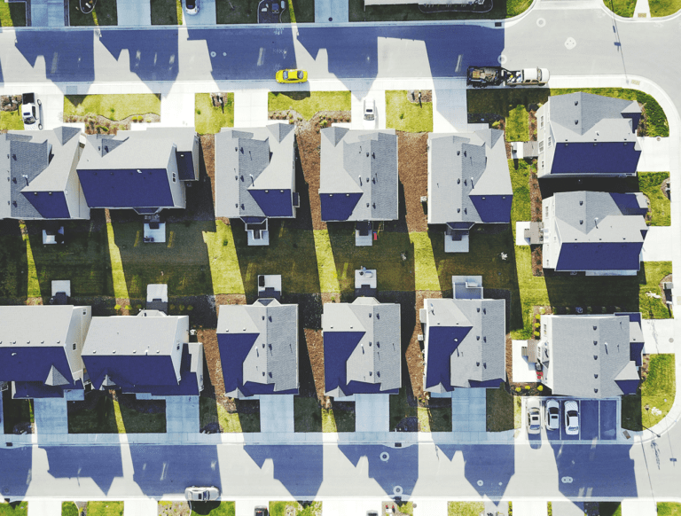 Several houses seen from above with solar panels.