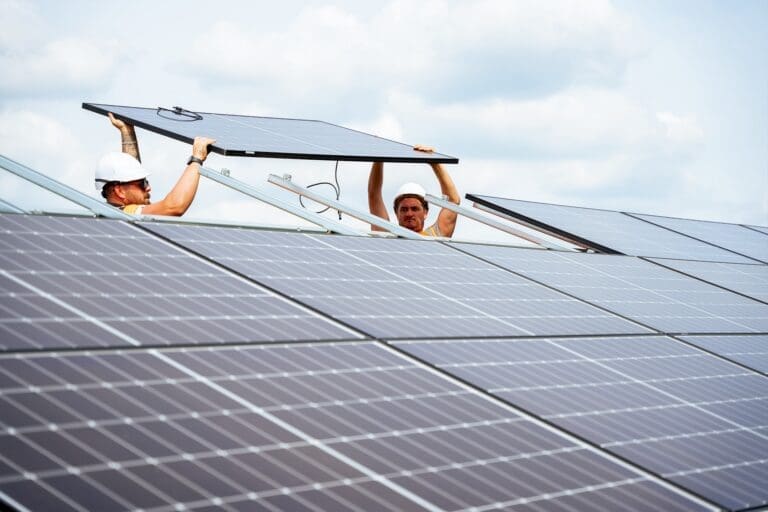 Two installers installing rooftop solar panels