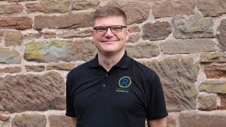 David Pierpoint of the Retrofit Academy stands in front of a wall