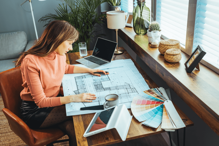 Female working on a busy desk.