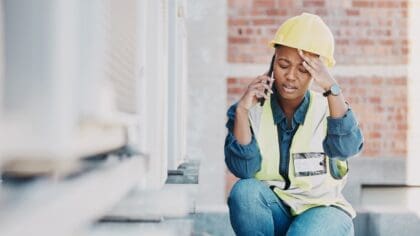 A stressed HVAC installer on the phone