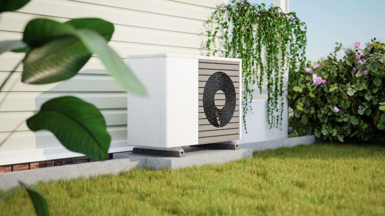 Photorealistic 3d render of a fictitious air source heat pump mounted to a concrete base with vibration dampers on the outside of a house. Rose bush, ivy and strelitzia in the garden.