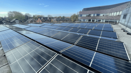 Picture of a rooftop with lots of solar panels on it.
